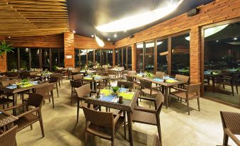 a large dining room with multiple tables and chairs arranged for a group of people to enjoy a meal together at Astoria Palawan