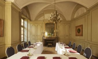 a long dining table set up for a formal event , with multiple chairs arranged around it at Château de Bagnols
