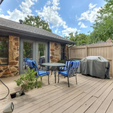 Quiet, spacious home with large deck in secluded Forest Oaks in central Edmond .