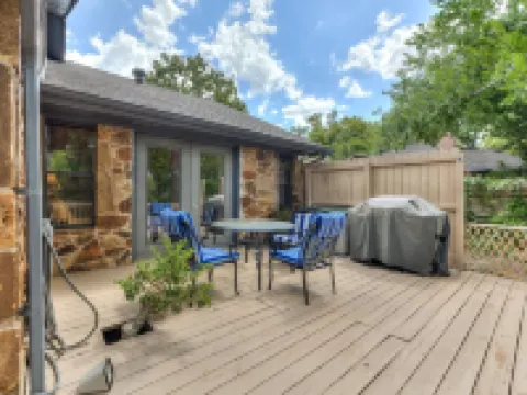 Quiet, spacious home with large deck in secluded Forest Oaks in central Edmond .