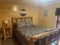 3BR, 2 Bath Cabin with full kitchen, living room, and hot tub.