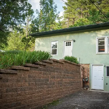 Remodeled home in the woods, just past city limits. With horse pasture nearby!