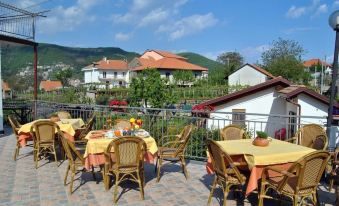 a patio with tables and chairs set up for a meal , overlooking a beautiful mountain view at Rabbit