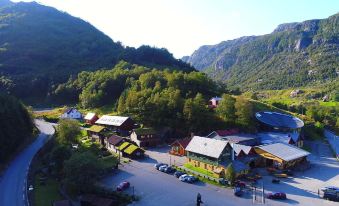 a bird 's eye view of a mountainous area with houses and buildings surrounded by trees at Byrkjedalstunet Hotell