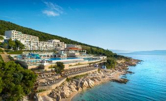 an aerial view of a resort on the beach , with a large pool surrounded by buildings at Valamar Bellevue Resort