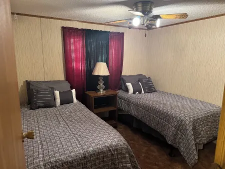 Cozi retreat set in the woods within walking distance of Waubee Lake.