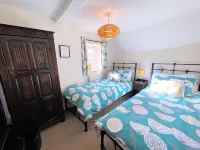 A Quaint Grade 11 Listed Detached Stone Cottage In Lower Slaughter with parking.