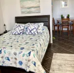 Coral Beach Retreat. Garden view. Steps from pool & beach. 1 mile to Port Lucaya