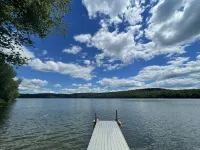 Cozy cabin with deck and fireplace steps from White Pond Lake. Dog friendly.