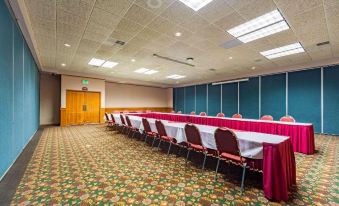 a large conference room with multiple tables and chairs arranged for a meeting or event at Siegel Select Bartlett Extended Stay in Tennessee