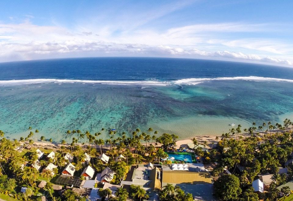 a bird 's eye view of a resort with palm trees and buildings overlooking the ocean at Fiji Hideaway Resort and Spa