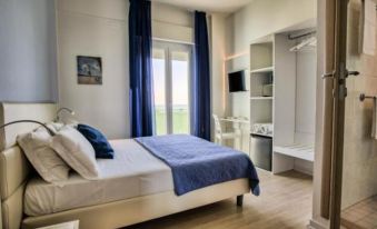 a modern bedroom with blue curtains , wooden floors , and a large window offering a view of the outdoors at San Marco