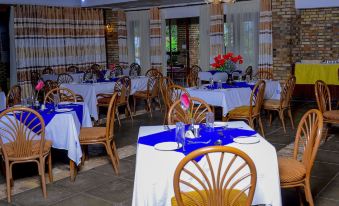 a dining room with several tables and chairs arranged for a group of people to enjoy a meal together at White Horse Inn