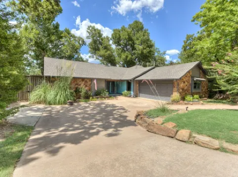 Quiet, spacious home with large deck in secluded Forest Oaks in central Edmond .