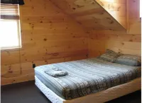 3BR, 1 Bath Cabin with hot tub, full kitchen, and living room.