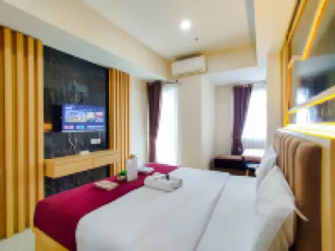 Wood Accents Studio at Grand Dharmahusada Lagoon Apartment by Travelio