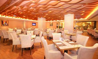 The restaurant features tables and chairs arranged in a central location, facing each other at Holiday Inn Macau