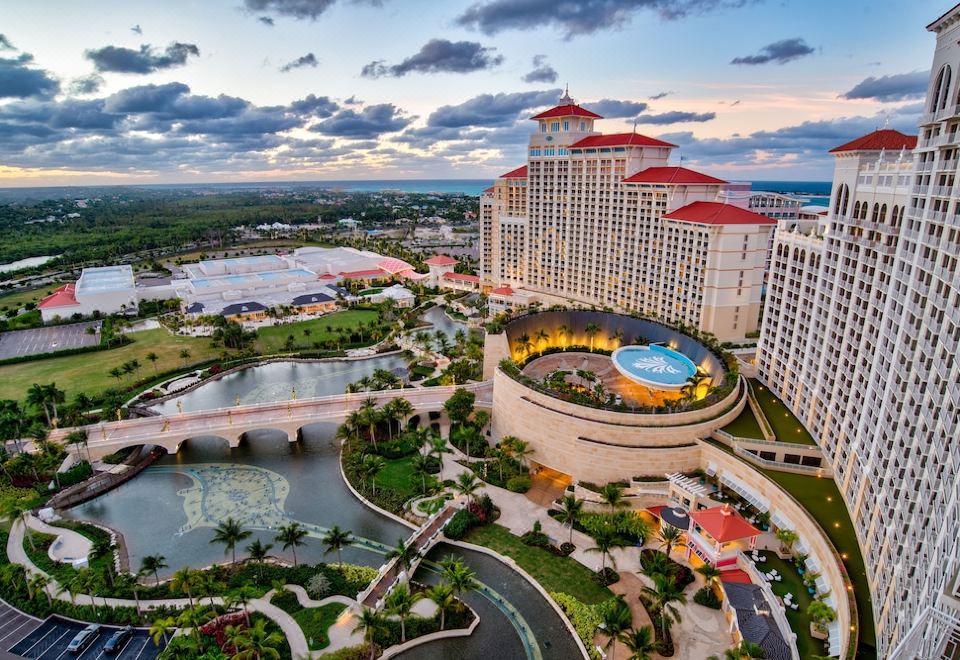 an aerial view of a large resort with a hotel and a pool surrounded by lush greenery at Grand Hyatt Baha Mar