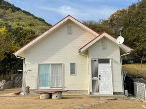 A House Surrounded By Mountains And The Sea On Sho