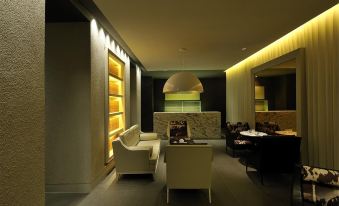 The room is illuminated by dim lighting and features large windows, as well as chairs and tables in the center at Jinjiang Inn Select (Shanghai Nanjing Road Pedestrian Street)
