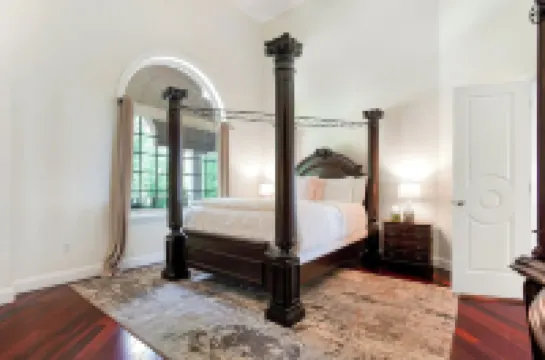 Stunning waterfront villa with indoor pool and kids swing set and play area.