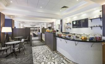 a dining area with a buffet table filled with a variety of food items , including sandwiches , fruits , and beverages at Doubletree by Hilton Dartford Bridge