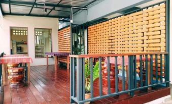 a dining room with wooden tables and chairs , as well as a potted plant on the table at The Sekret Hotel