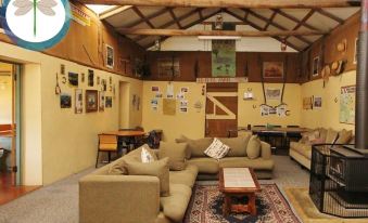 a cozy living room with several couches and chairs arranged in a comfortable seating area at Fernleigh Accommodation