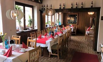 a dining room with tables and chairs arranged for a large group of people to enjoy a meal together at Hotel Zur Post Limburg Bad Camberg