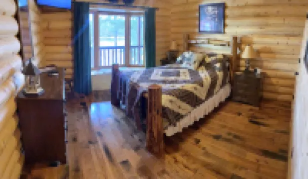 Large six-bedroom loghome w/ private boat ramp, dock, movie room and pool room.
