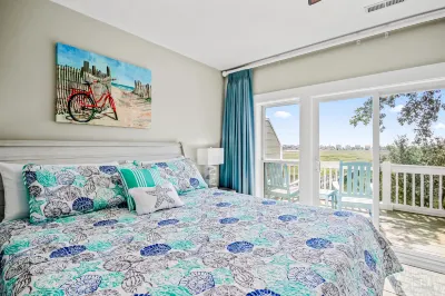 Coastal marsh/water-view townhome with sunroom, AC, & washer/dryer
