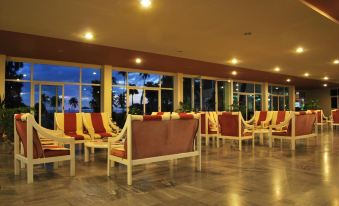 a modern , well - lit lobby with large windows and multiple reclining chairs , offering a relaxing atmosphere at Colony