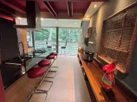 5-Bedroom 6000SF wood and glass retreat in Atlanta, surrounded by greenery.