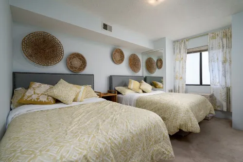Contemporary, clean 1-bedroom mid-town condo with bay view and 1 block to beach.