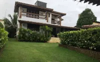 Cozy and charming house with pool and gardens in sea front condominium!