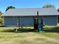 BEAUTIFUL lake front home with a private beach, dock and large yard