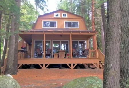 Famous cottage directly on 100' private shoreline of pristine lake.