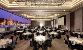 a large , well - lit banquet hall with numerous tables and chairs set up for an event at Crowne Plaza Lombard Downers Grove