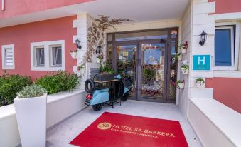 "a blue motorcycle parked in front of a red door with the words "" hotel da barrera "" written on it" at Hotel Sa Barrera - Adults Only