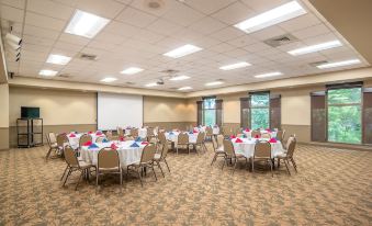 a large room with round tables and chairs is set up for a meeting or event at Carter Caves State Resort Park