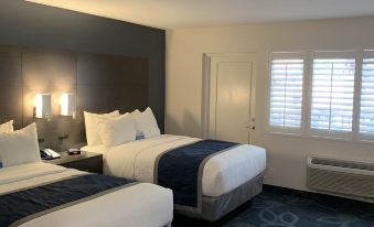 a hotel room with two beds , one on the left side and the other on the right side of the room at The Historic Brookdale Lodge, Santa Cruz Mountains