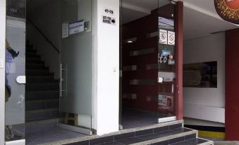 "a building entrance with a glass door and steps leading up to it , accompanied by a sign that says "" hi .""." at Hotel Perlatto