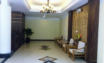 a spacious lobby with wooden chairs and a chandelier , creating a warm and inviting atmosphere at Saigon-Ba Be Resort