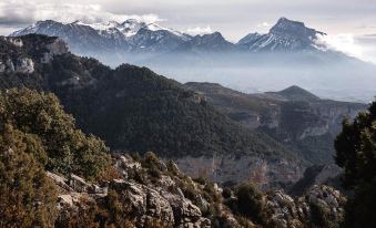 a scenic view of a mountain range with snow - capped peaks and green trees in the foreground at Casa Marina