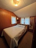 Charming 2-bedroom cabin sits on 2.5 acres on Hubbard Lake.