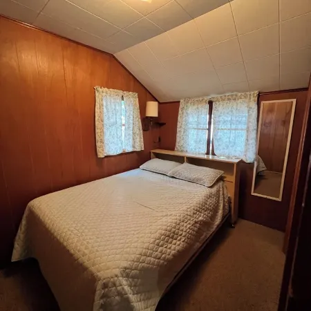 Charming 2-bedroom cabin sits on 2.5 acres on Hubbard Lake.