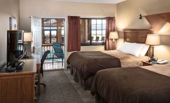 a hotel room with two beds , one on the left and one on the right side of the room at Arrowwood Resort at Cedar Shore