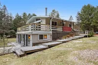 Lakefront Home with a Private Dock, Deck, Fireplace, Spacious Yard, & Playset