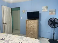 Tropical one bedroom condo steps from pool.