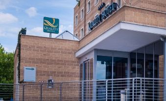 "a brick building with a sign that reads "" quality inn "" prominently displayed on the front of the building" at Quality Hotel Green Palace